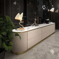 Elegant butterfly lamp chandelier illuminating a modern living room setting with sleek furniture and decorative plants.