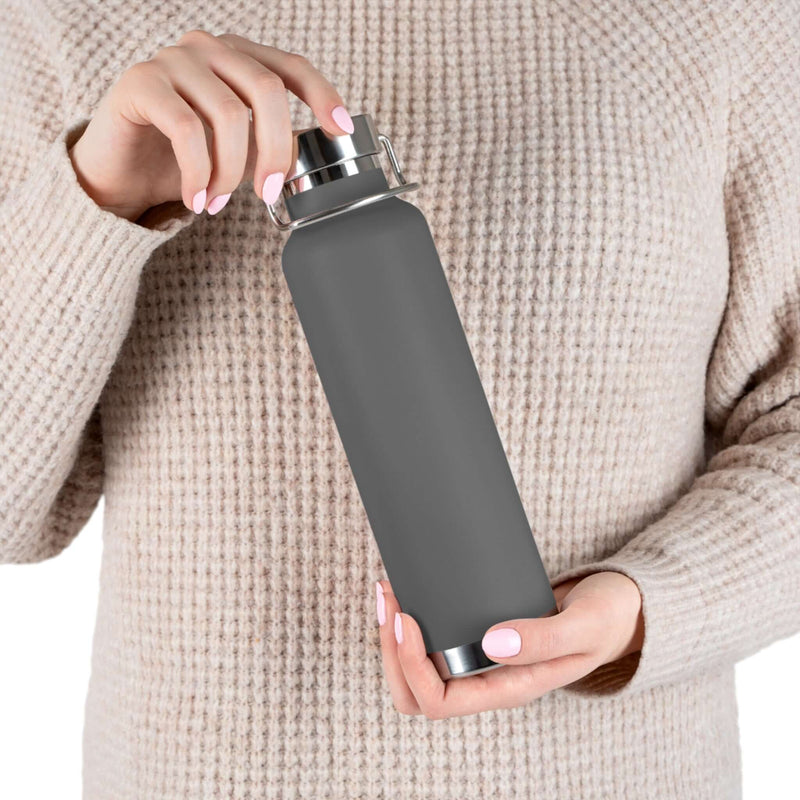 body view of person holding Copper Vacuum Insulated Bottle, 22oz