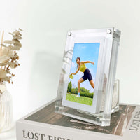 Modern acrylic digital picture frame displaying a vibrant outdoor photo on a stylish home display, showcasing a woman playing sports.