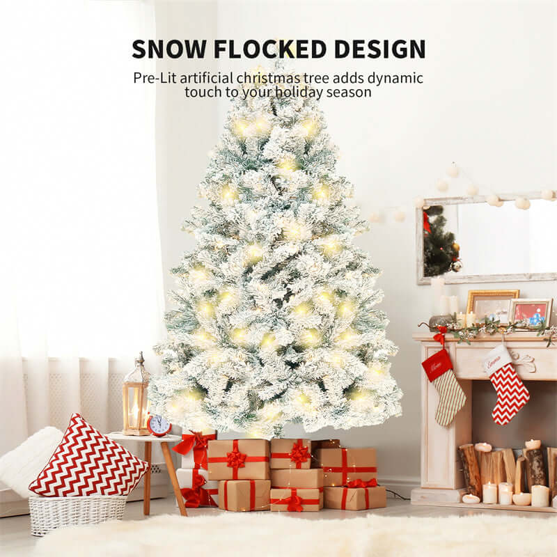 Snow flocked pre-lit artificial Christmas tree with gifts underneath, set up in a cozy living room decorated for the holiday season.